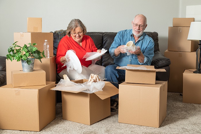 Couple Packing Storage Boxes for Downsizing need storage in Alexandria